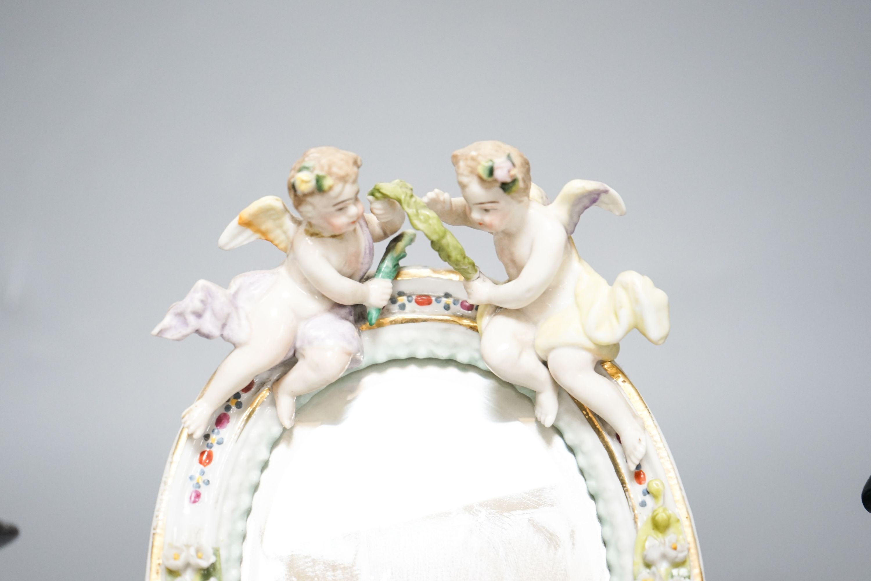 A pair of Meissen groups holding chickens, 10.5cm, a pair of Sitzendorph figures and a Sitzendorf mirror 18cm